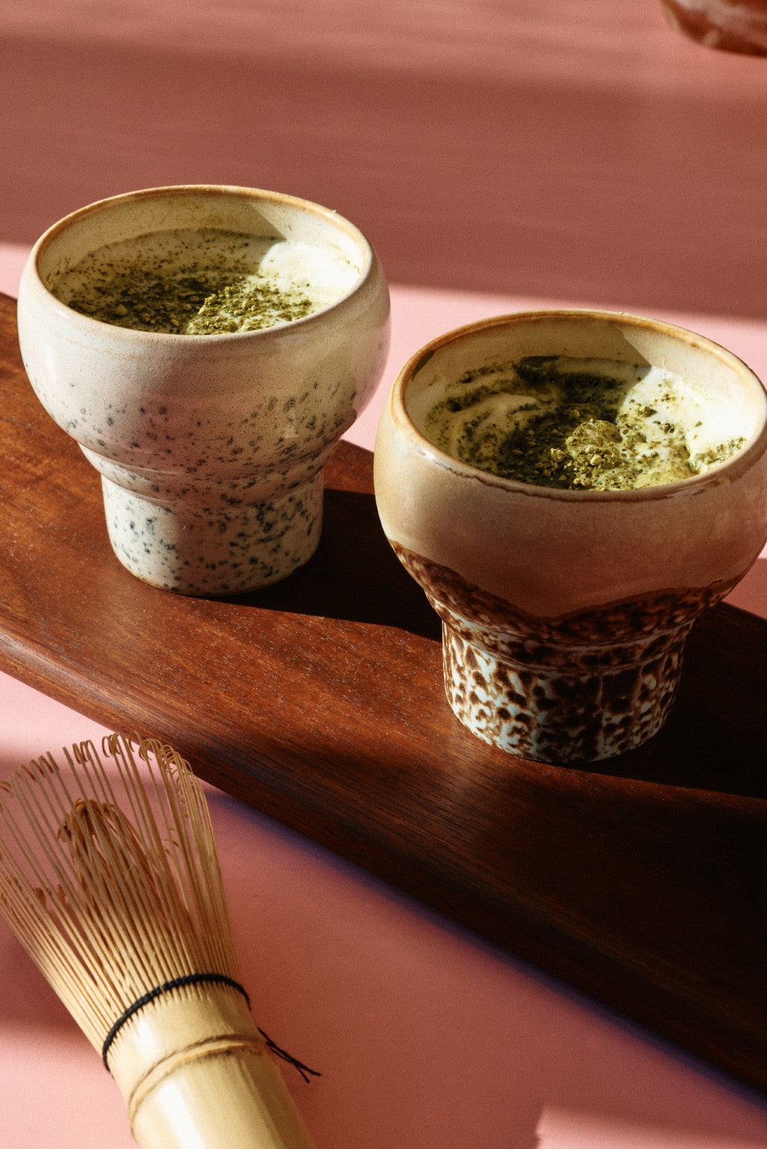 two mugs filled with matcha drink