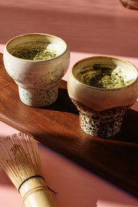two mugs filled with matcha drink