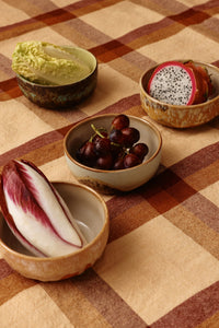 Dishes with vegetables on a checkered tablecloth