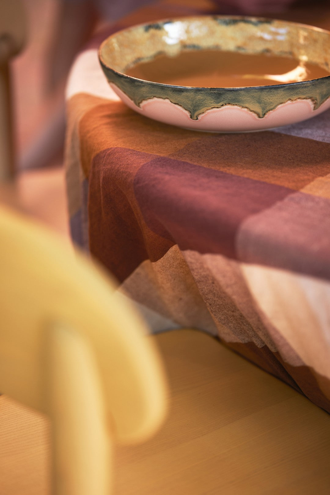 Ceramic bowl on a checkered tablecloth with a blurred background