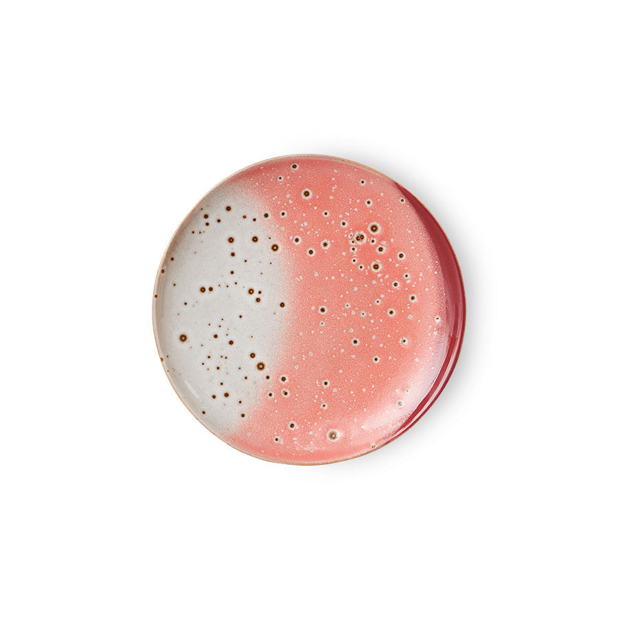 Speckled ceramic plate with pink and white gradient on a white background