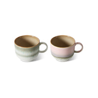 Two ceramic mugs with gradient colors on a white background