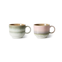 Two ceramic mugs with a textured finish on a white background