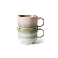 Two ceramic mugs with gradient colors stacked on a white background