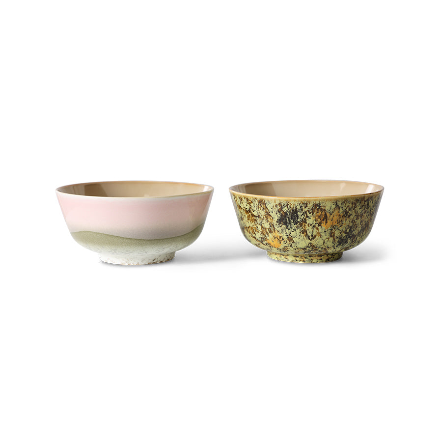 Two ceramic bowls with different earthy color palettes on a white background