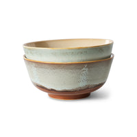 Set of two ceramic bowls with textured surfaces on a white background