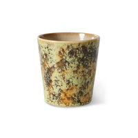 Ceramic cup with rustic design on a white background