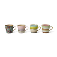 Set of four ceramic mugs with multicolored glazes on a white background