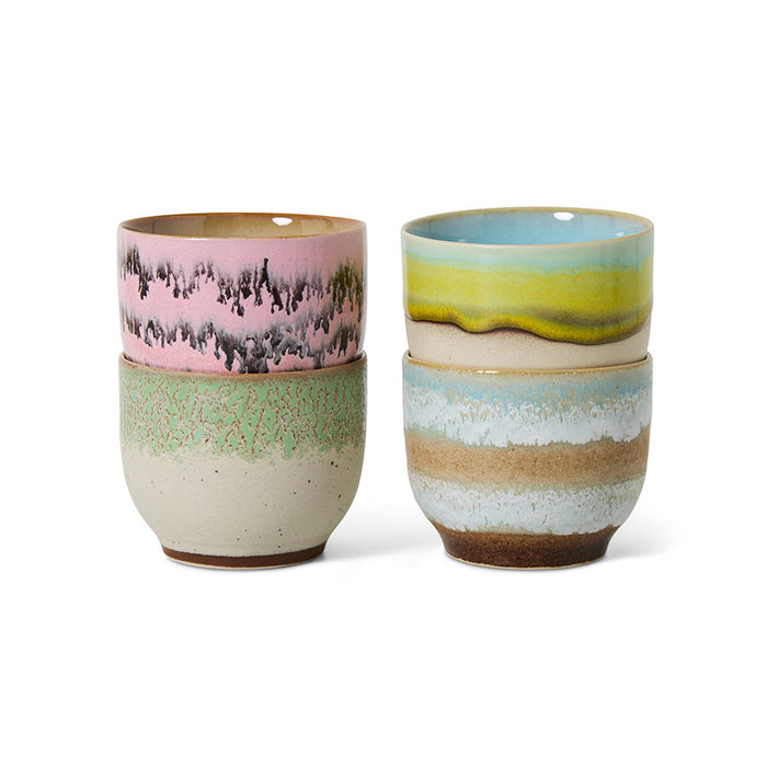 Two ceramic cups with multicolored glazes on a white background