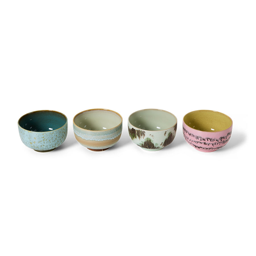 Set of four ceramic bowls with different patterns and colors on a white background
