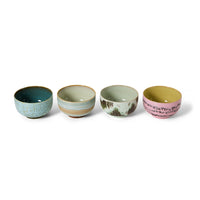 Set of four ceramic bowls with different patterns and colors on a white background