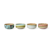 Four ceramic bowls with different patterns on a white background