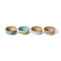 Four ceramic bowls with different patterns on a white background