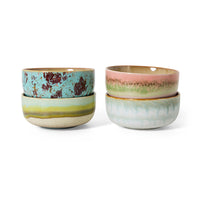 Two sets of ceramic bowls with multicolored glazes on a white background