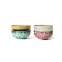 Two sets of ceramic bowls with textured surfaces on a white background