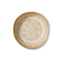 Beige ceramic bowl with gold rim on a white background