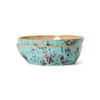 Turquoise ceramic bowl with gold rim on a white background
