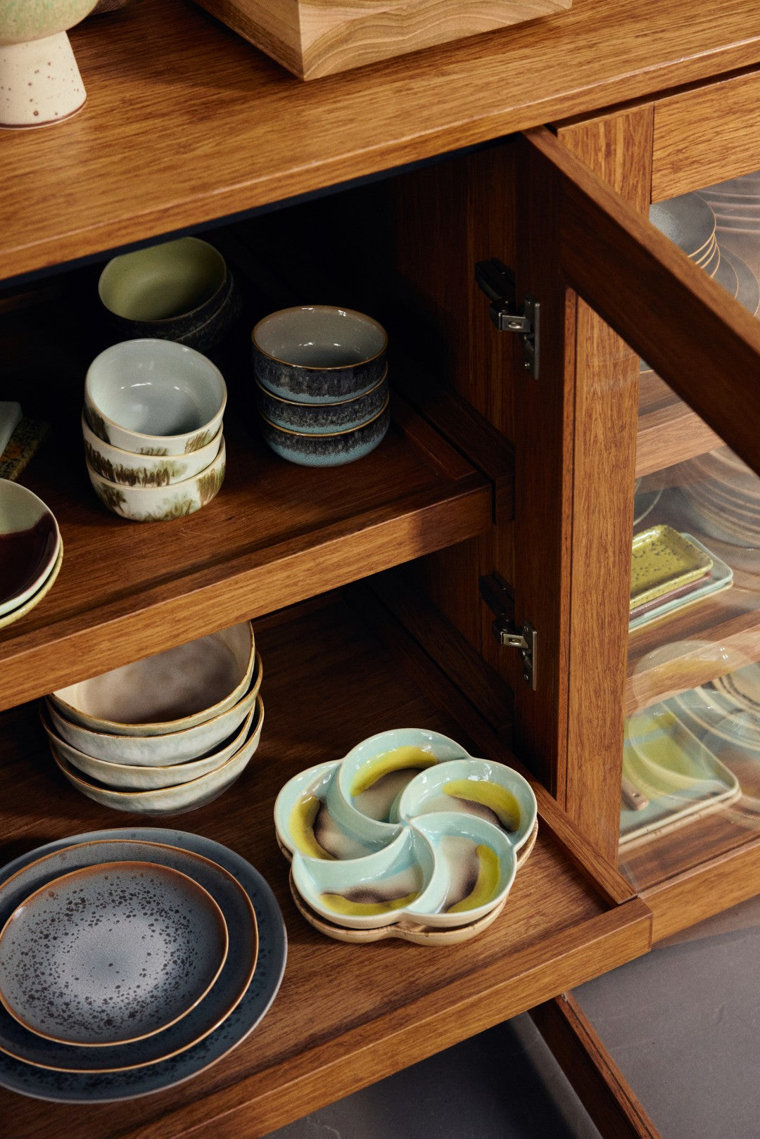 Wooden cabinet with ceramic dishes inside