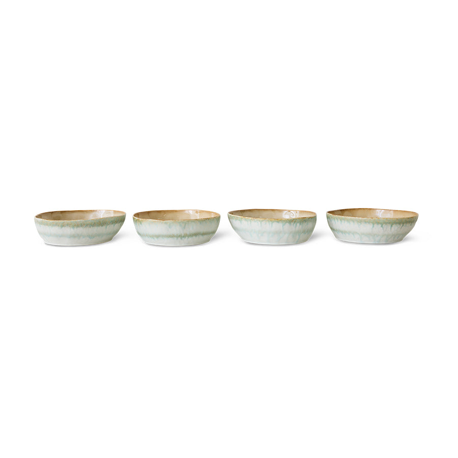 Four ceramic bowls with a subtle pattern on a white background