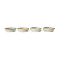 Four ceramic bowls with a subtle pattern on a white background