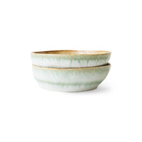 Two ceramic bowls with a green and gold pattern on a white background