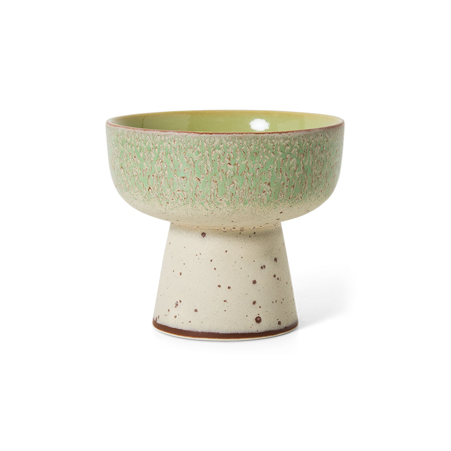 Ceramic bowl with a green top and beige base on a white background