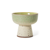 Ceramic bowl with a green top and beige base on a white background