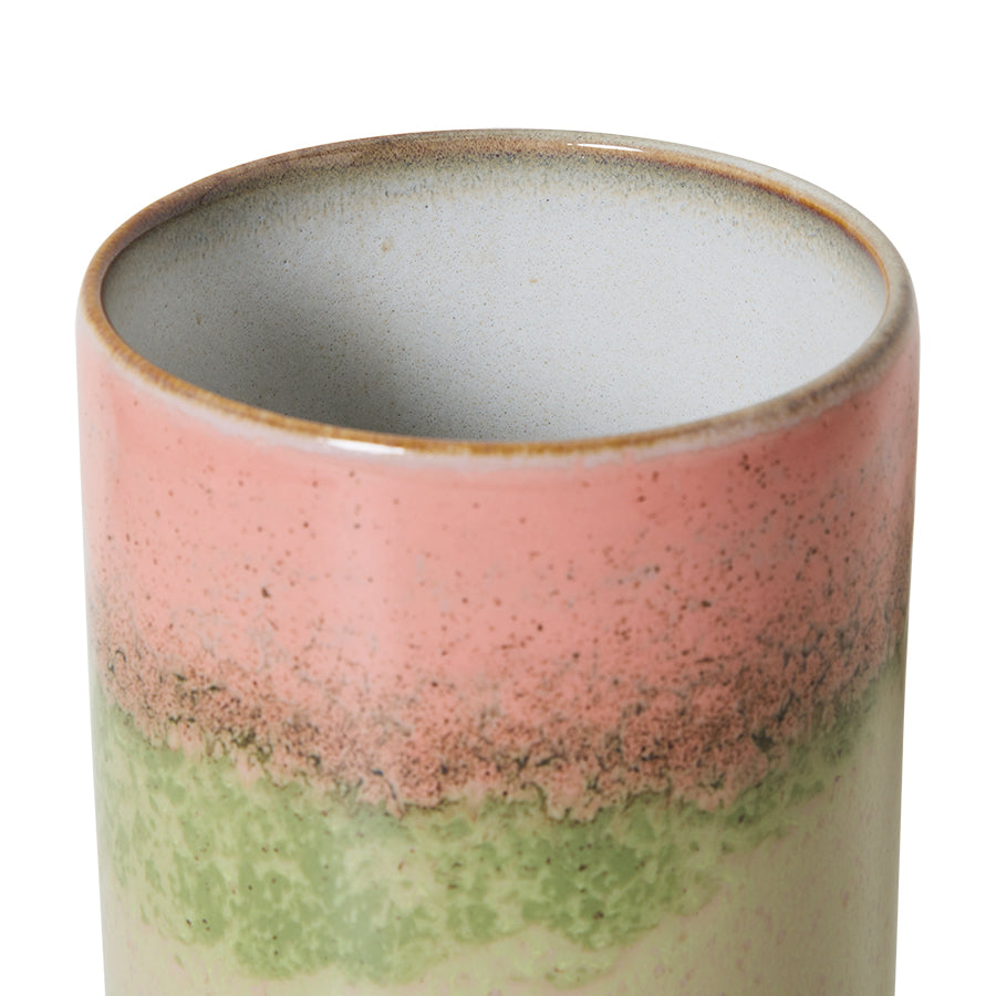 Ceramic cup with multicolored glaze on a white background