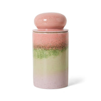 Pink ceramic jar with gradient color design on a white background