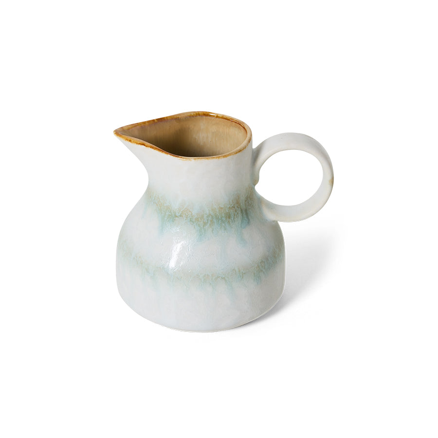 White ceramic pitcher with brown rim on a white background