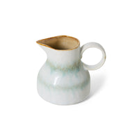 White ceramic pitcher with brown rim on a white background