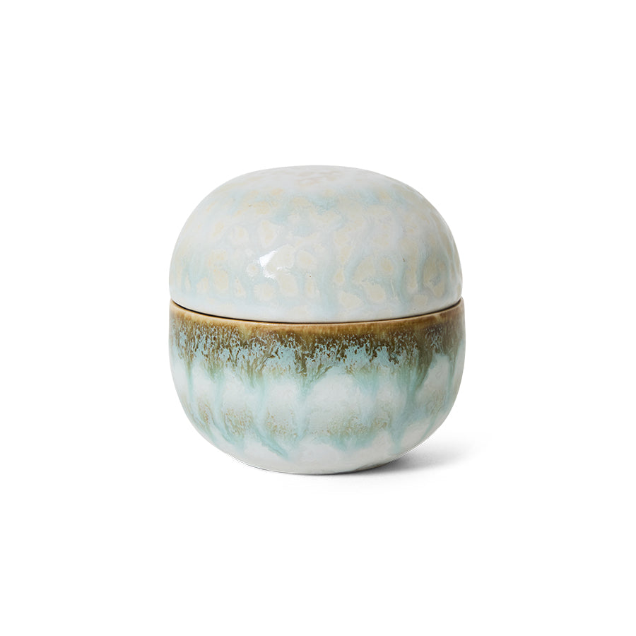 Round ceramic container with a textured surface on a white background