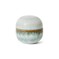 Round ceramic container with a textured surface on a white background