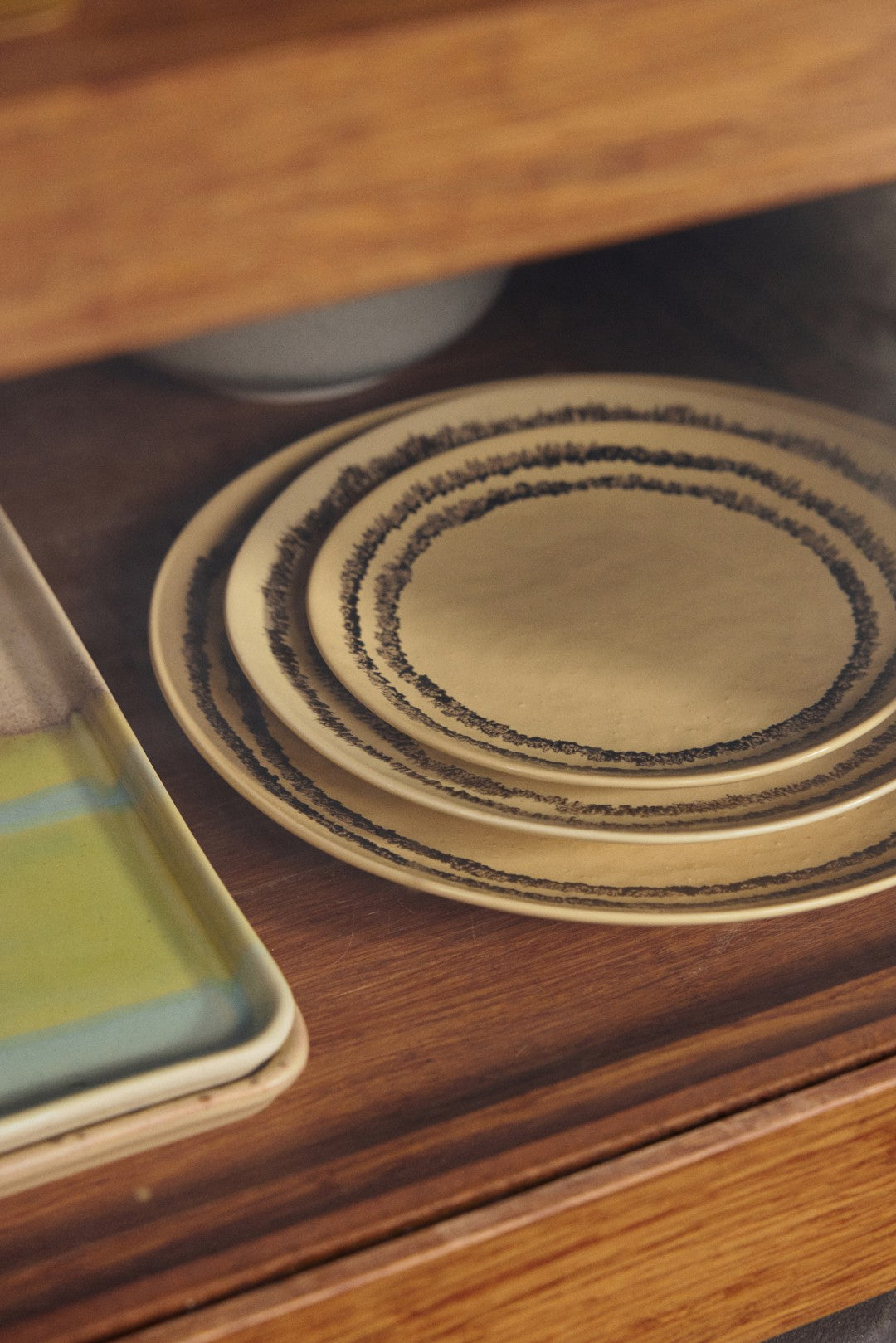 Set of ceramic plates on a wooden surface
