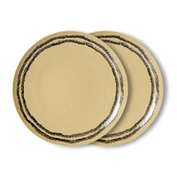 Two beige plates with black rim on a white background
