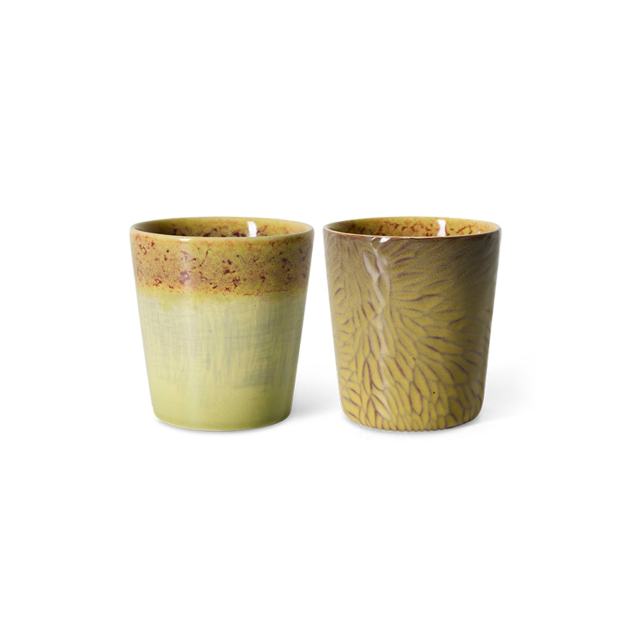 Two ceramic cups with textured surfaces on a white background