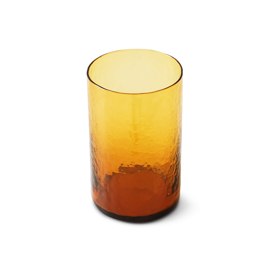 Amber glass tumbler on a white background