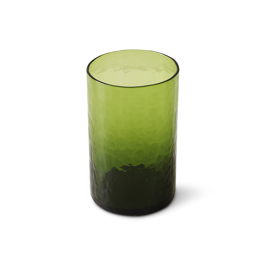 Green glass tumbler with textured design on a white background