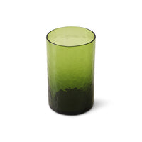 Green glass tumbler with textured design on a white background