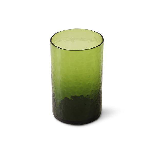 Green glass tumbler with textured design on a white background
