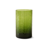 Green glass tumbler on a white background