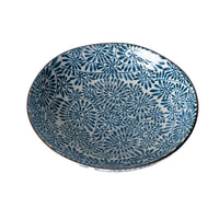 Ceramic bowl with blue floral pattern on a marble surface