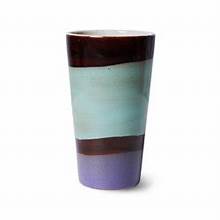 Multicolored ceramic tumbler on a white background