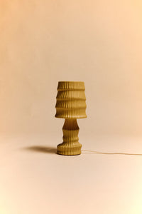Small ribbed table lamp on a beige background