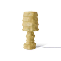 Beige textured table lamp on a white background