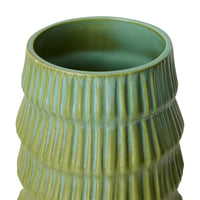 Green ceramic vase with textured surface on a white background