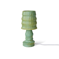 Green ribbed table lamp on a white background