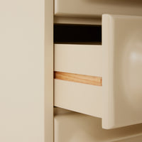 Beige drawer with wooden handle in a cabinet