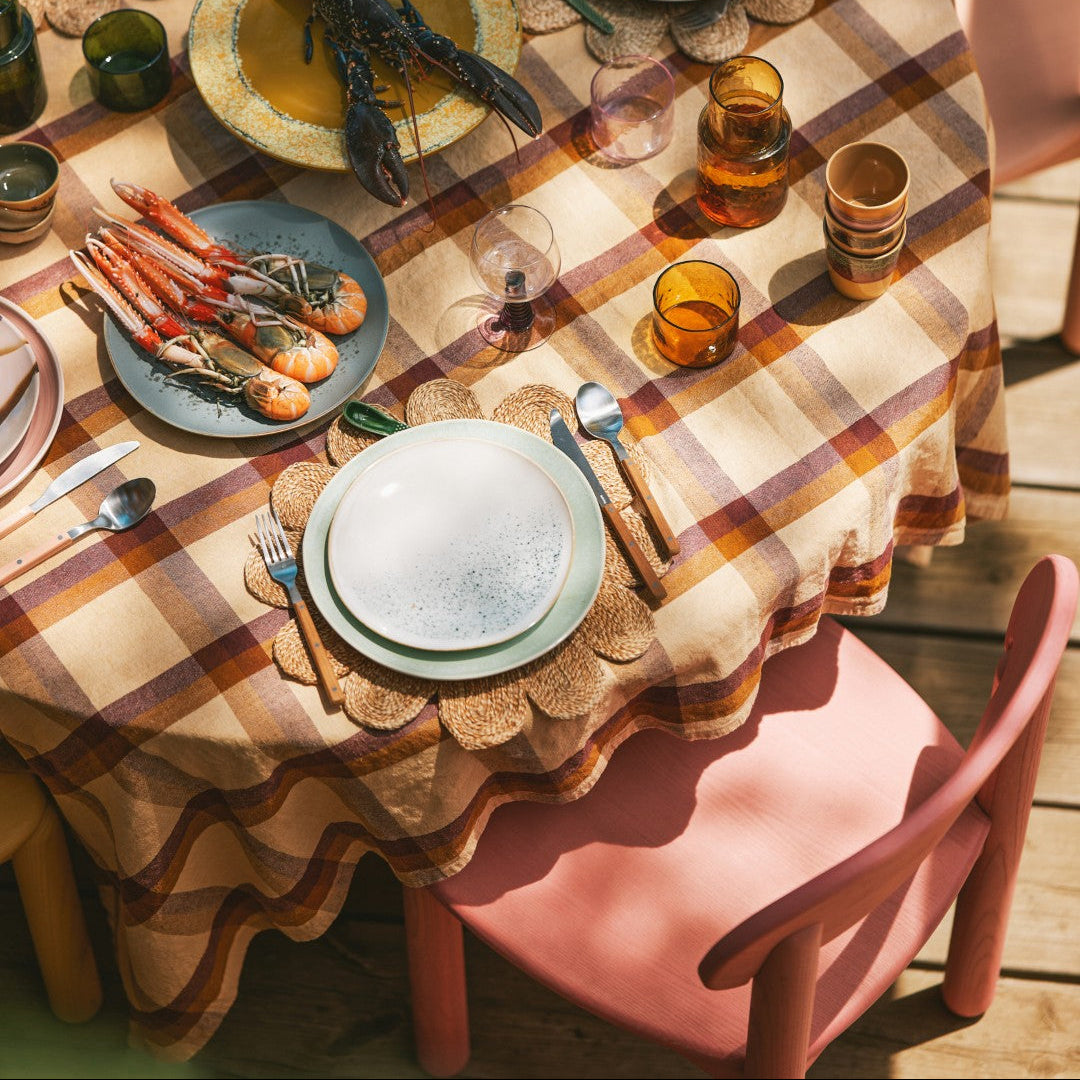 table with table cloth and mixed tableware and food