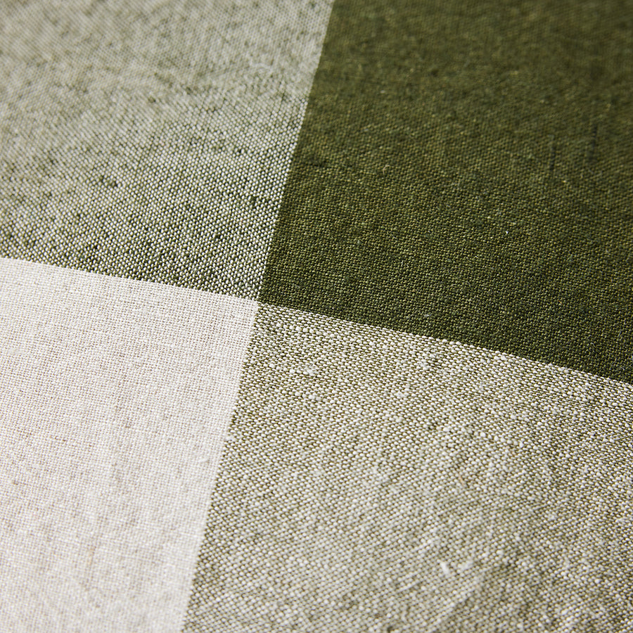 Close-up of fabric with green, gray, and white checkered pattern